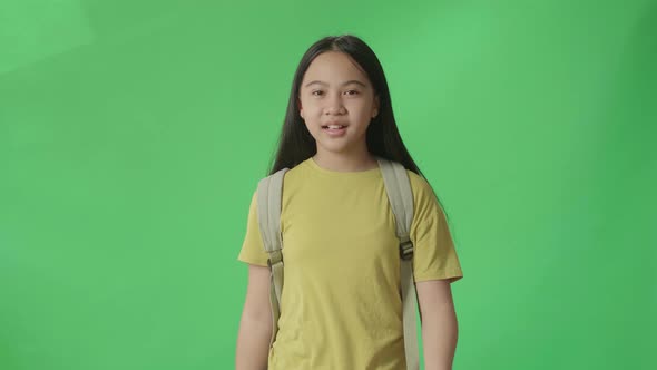 Asian Girl Student Walking To School On Green Screen Chroma Key alt