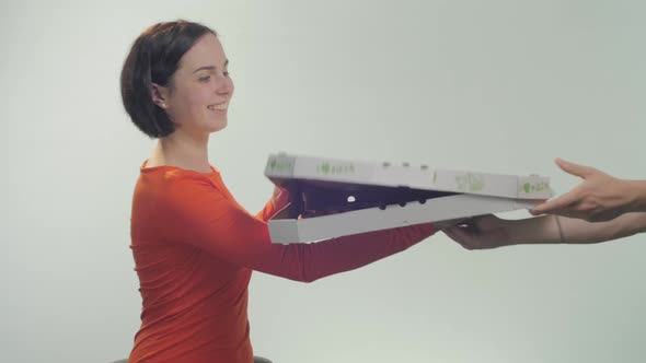 Happy woman receiving pizza alt