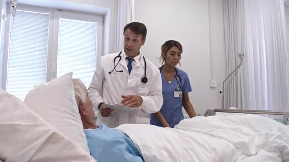 Doctor Consulting Senior Patient in Comfortable Private Ward alt