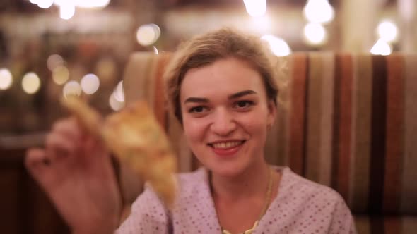 Woman Eating Pizza in Restaurant alt