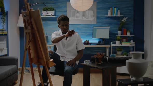 Black Artist Analyzing Vase for Drawing Design alt