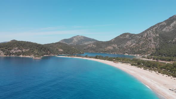 Aerial Flying Oludeniz Beach and Lagoon Beautiful Bay Crystal Blue Water Turkey alt