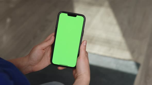 Close-up Shot of Green Screen Template Smartphone in Female Hands at Home alt