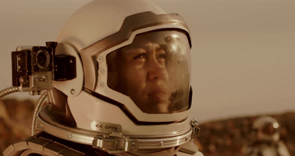Female Cosmonaut Recording Video During Expedition on Mars alt