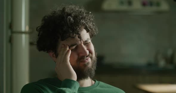 Portrait of a Young Bearded Man with a Headache