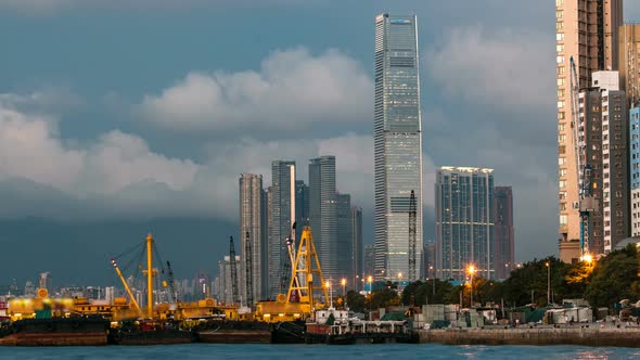 Hong Kong Business Center Day To Night Timelapse with a Cloudy Blue Sky Before Sunset alt