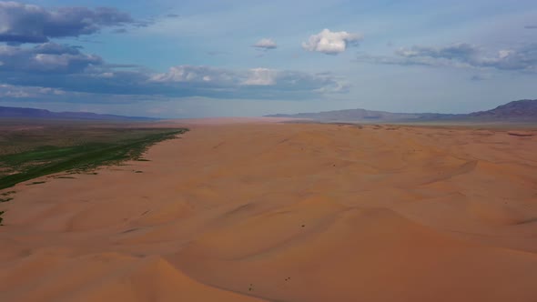 Aerial View of Sand Dunes in Desert at Sunset alt