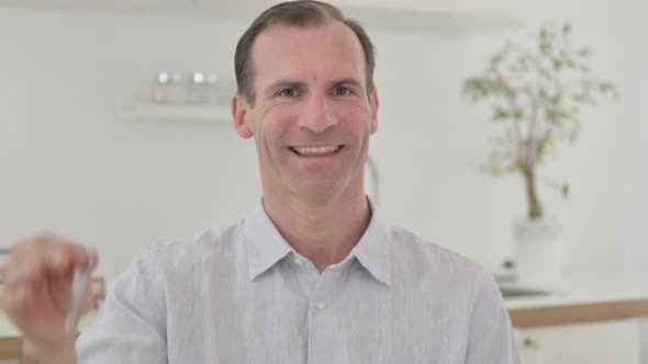 Ambitious Middle Aged Man Holding Keys alt