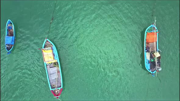 Drone Removes From Close View of Fishing Boats To Ocean View alt