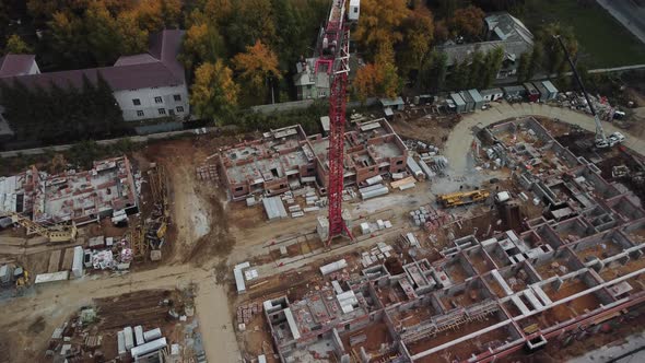 Aerial view of construction site with crane and buildings under construction.