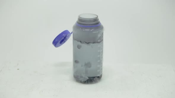 Dry ice cube bubbling in a bottle alt