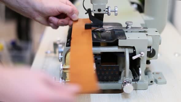 Close Up View of a Process of Making Leather Craftwork. Worker Using Skiving Machine alt