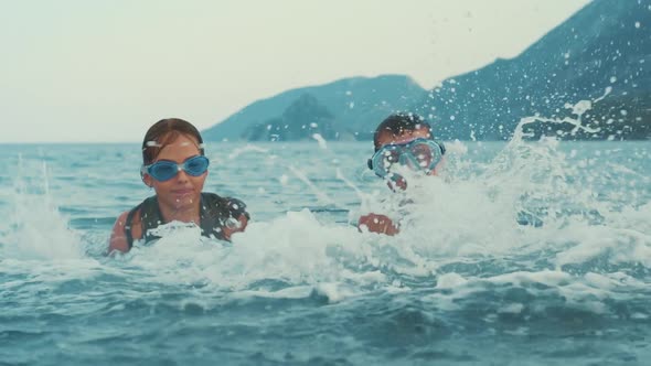 Children Enjoy Warm Sea Water. Two Kids Playing Together in Ocean Water alt