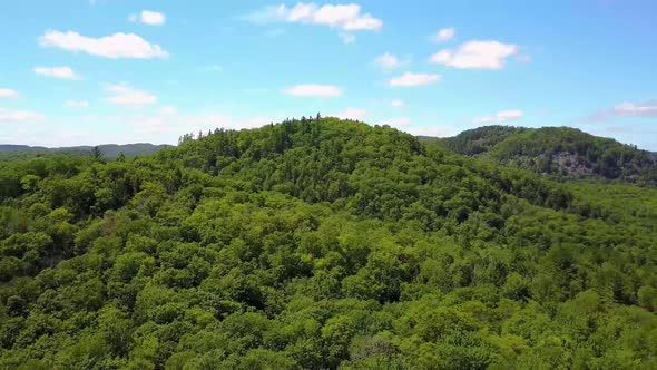 Drone Flying Above Green Hilltops alt