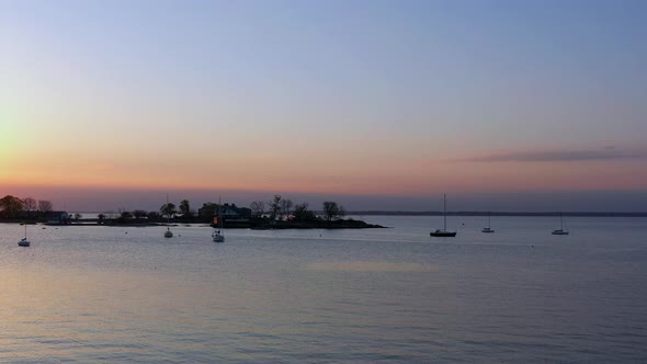 A wide angle shot of a beautiful sunrise in a colorful sky. It was taken over the water with the dro alt