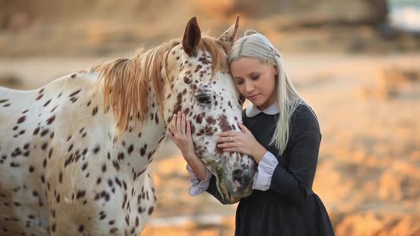 Slow Motion Young Blonde Woman Stroking And Hugging White Horse Full