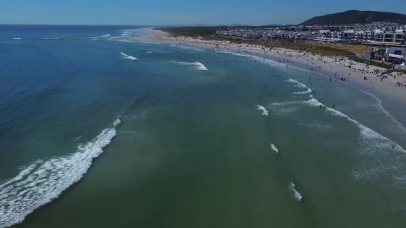 Drone shot of Blouberg beach in Cape Town - drone is flying over Big Bay surfers beach. Snippet coul alt