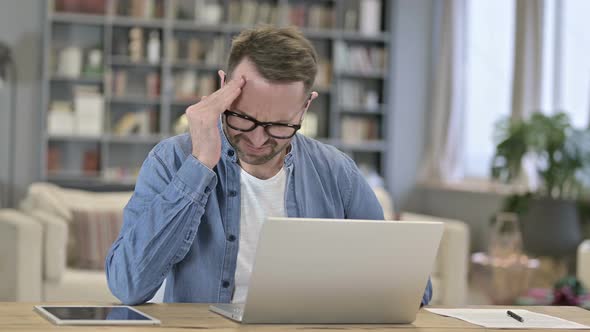 Tired Young Man Having Headache in Loft Office  alt