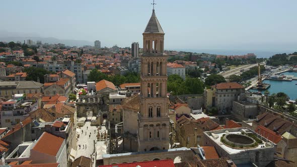 Aerial drone rotating shot of Diocletian's Palace, the bell tower of the cathedral of St Domnius in alt