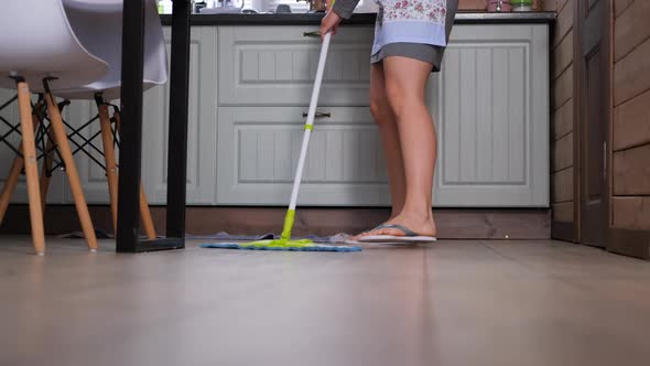 Woman Washing Floor with Mop in the Kitchen alt
