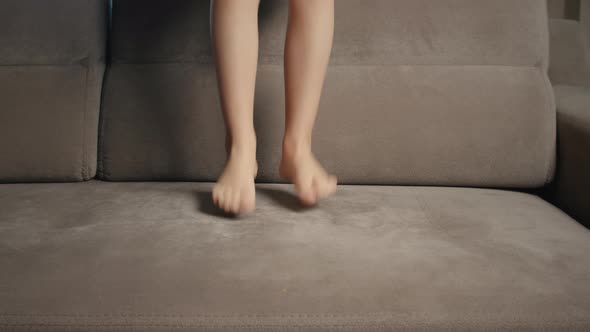 Child jumping on the couch bed