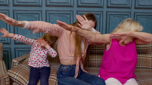 Young Woman Doing Dab Gesture Internet Meme with Senior Old Grandmother and Small Kid Child Girl alt