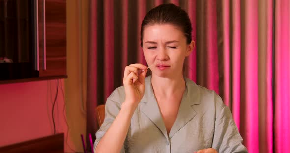 Closeup young woman taking COVID-19 rapid test at home alt