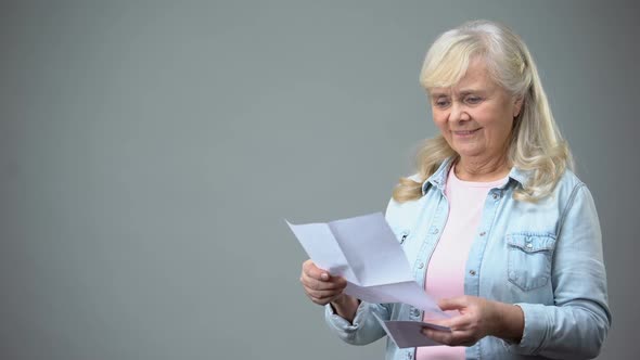 Aged Retiree Lady Reading Letter From Children Receiving Good News Loan Approval alt
