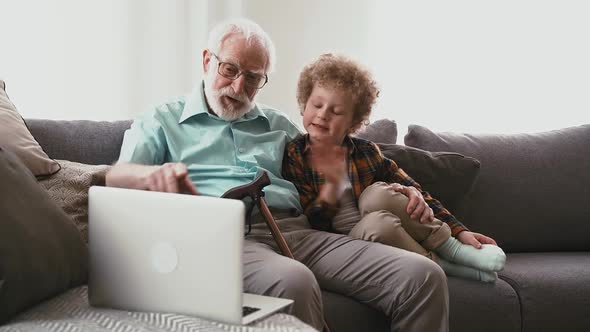 Grandparents plying with grandson. alt