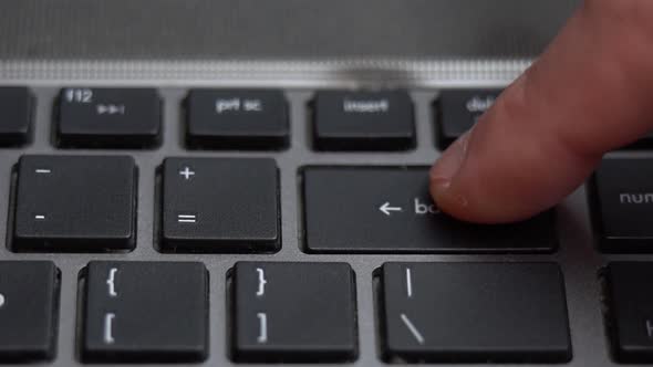 Backspace Button Pressing a Lot of Times on Keyboard Laptop Keyboard Close Up alt