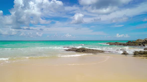 Seascape in sunny day white clouds beautiful blue sky rock and sand beach Phuket Thailand alt