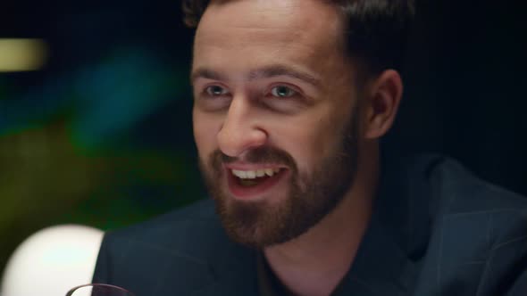 Smiling Man Drinking Wine Glass in Fine Restaurant alt