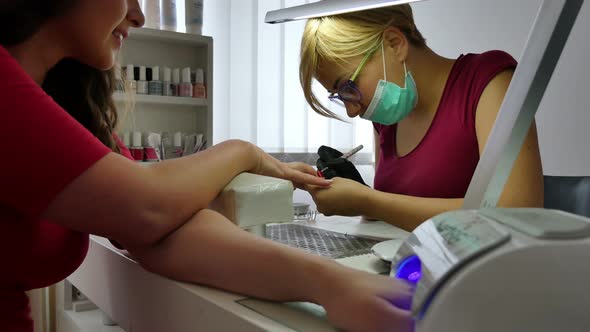 Woman at Manicure Treatment