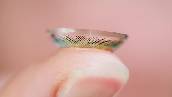 Closeup of a Colorful Lens on Finger Decorative Lenses alt