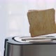 Bread popping up of steel toaster in the kitchen. - VideoHive Item for Sale