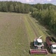 Aerial view of two Combines harvesting, trucks and tractor on grass field. 37 - VideoHive Item for Sale