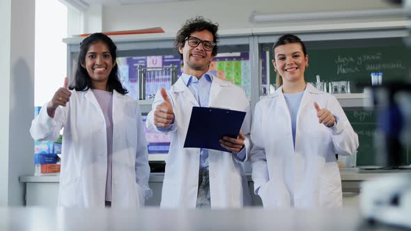 Happy Scientists Showing Thumbs Up in Laboratory