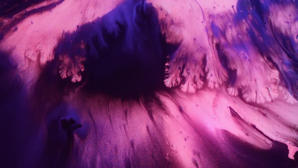 Macro Footage of Ethereal Pink Paint and Glitter Particles Spreading alt