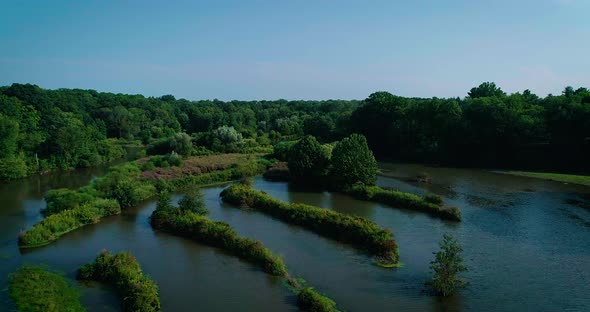 Aerial footage of wetland and a river that flows through. alt