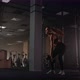 A Strong Woman Makes Efforts and Overcoming Difficulties Lifts a Dumbbell in a Dark Gym - VideoHive Item for Sale