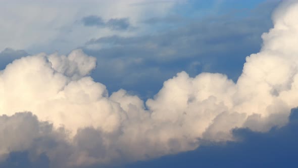 Fluffy cloud time lapse on a cloudy day 4k footage. alt