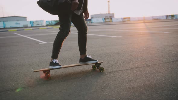 Close Up Shot of Man Riding on Longboard During Sunset Slow Motion alt