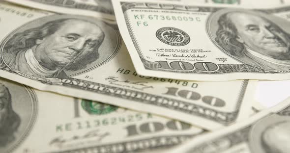 One hundred dollar bills, banknotes in motion. Close-up of money. Finance concept. alt