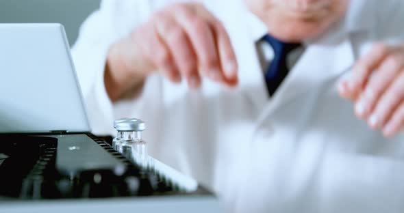 Male scientist placing medical vials on a rack 4k alt