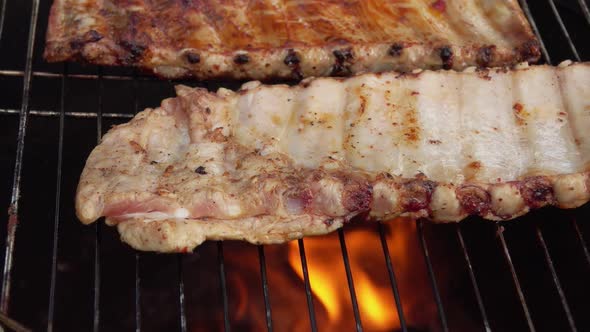 Closeup of the Halfprepared Spiced Ribs Frying on the Grill Grid alt