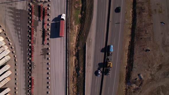 Overhead view of car and truck traffic at container shipping terminal of Vancouver in Canada. Aerial alt