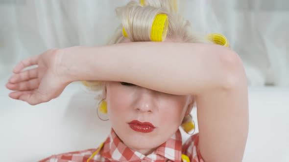 Portrait of a Young Housewife in Hair Curlers alt