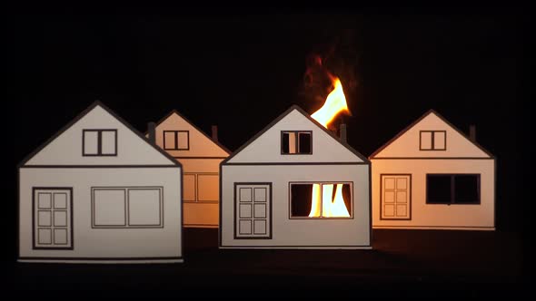 Burning paper house as a symbol of fire damage. alt