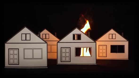 Burning paper house as a symbol of fire damage.