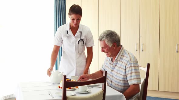 Nurse offering a cake to his patient alt
